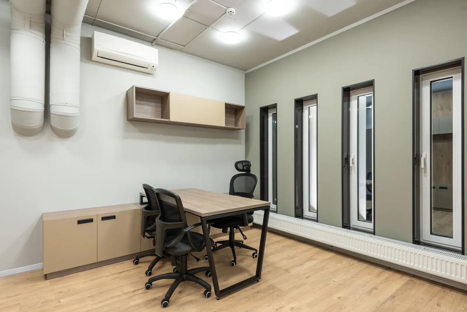 An office with a wall-mounted air conditioning unit