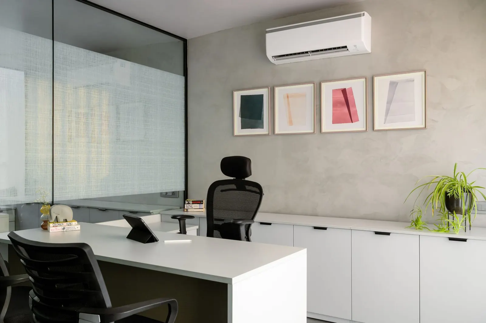 A modern office with a wall-mounted air conditioning unit